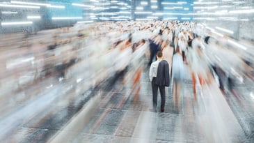 A person standing in a fast moving crowd