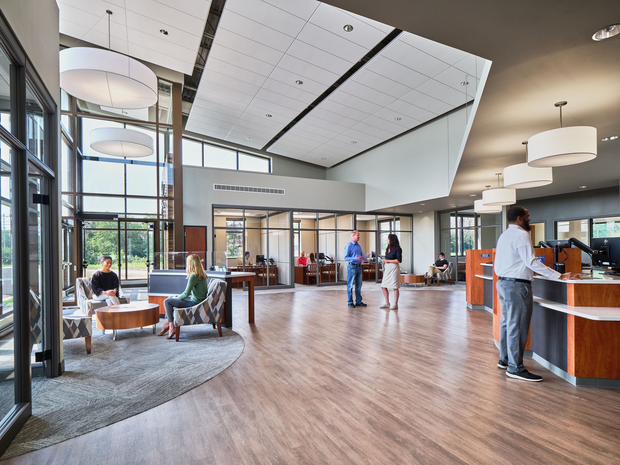 People interacting with each other in the Landmark Credit Union lobby